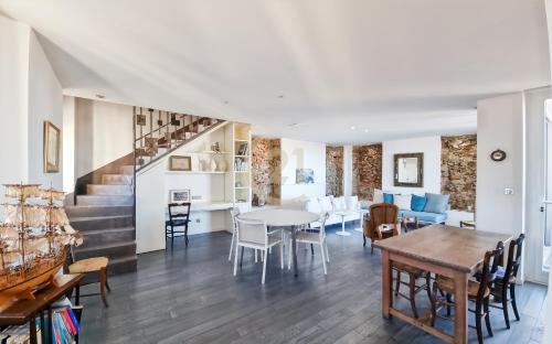 une salle à manger et un salon avec une table et des chaises dans l'établissement Superbe T5 centre-ville vue mer, à LʼÎle-Rousse