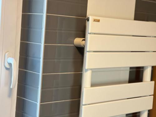 a bathroom with a white door and blue tiles at Isa'Bellescale - Fully equipped house 2km from Brussels South Airport in Ransart