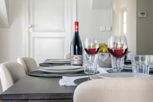 - une table avec une bouteille de vin et des verres dans l'établissement Le Passage du Roi - Hypercentre, à Tours
