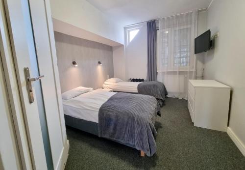 Postel nebo postele na pokoji v ubytování Hotel Orbita