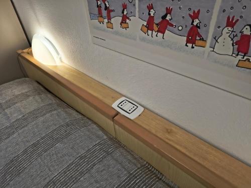 a room with a bed with a thermometer on it at Domo de Logu SOS TRES RES in Nuoro