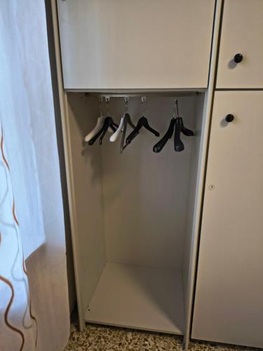 a closet with hangers of shoes in it at Domo de Logu SOS TRES RES in Nuoro