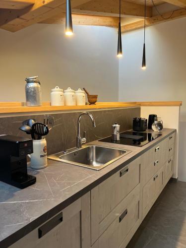 a kitchen with a sink and a counter top at Casa Delfina in Grosotto