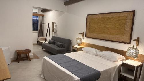 a bedroom with a bed and a chair and a couch at Village Sana Apart Hotel in Sana