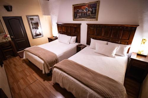 Ένα ή περισσότερα κρεβάτια σε δωμάτιο στο Hotel Casa San Miguel