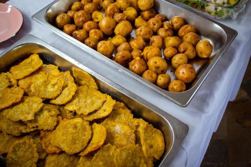 three metal trays of food on a table at Hotel Isla Real in Tierra Bomba