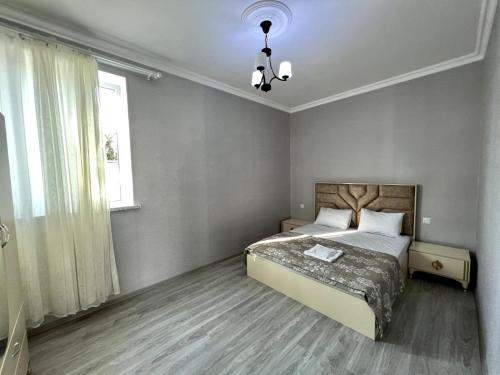 a bedroom with a large bed and a window at Villa Riverside in Gabala