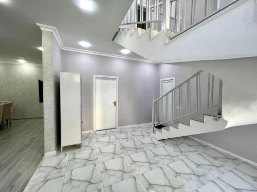 a hallway with a staircase and a stone floor at Villa Riverside in Gabala
