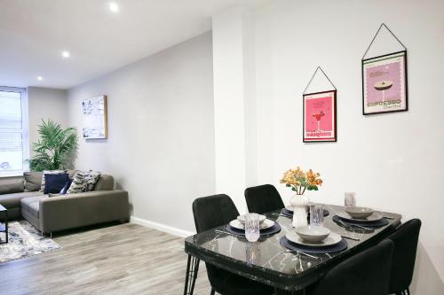 a living room with a table and chairs at Churchill Square Views - Central - Modern 1 Bed Sleeps 4 in Brighton & Hove