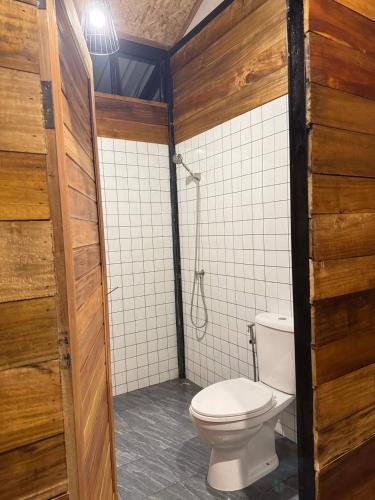 a bathroom with a toilet and a shower at Kohmook Nurse House in Koh Mook
