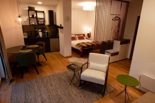 a small room with a bed and a table and chairs at Zlatar mountain retreat in Nova Varoš