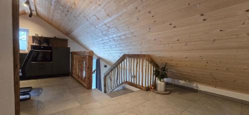 a staircase in a room with a wooden wall at Hafner- Appartments in Saalfelden am Steinernen Meer