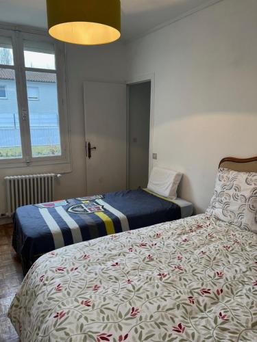 a bedroom with two beds and a window at Nantes Maison entière 5 lits La Coulée in Nantes