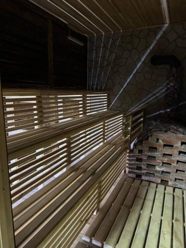 a wooden bench in a room with a window at Карпатська Криївка in Yasinya