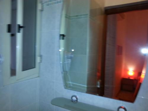 a bathroom with a mirror and a sink at Amarfia Bed & Breakfast - Your Home In Salerno in Salerno