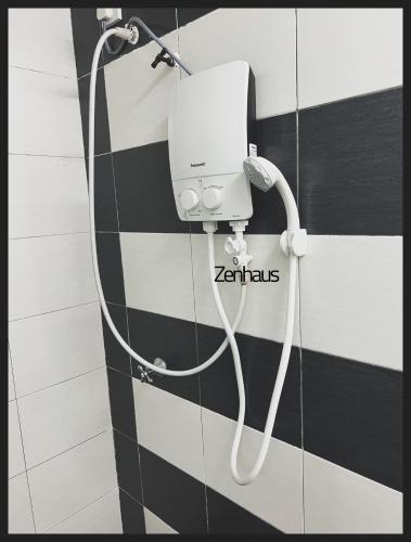 a white hand dryer on the wall of a bathroom at THE CEO LOFT by Zenhaus in Bayan Lepas