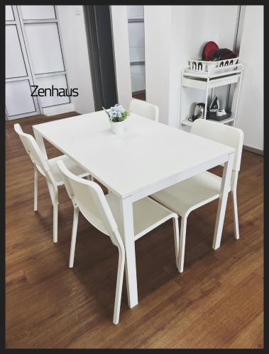 a white dining room table with white chairs at THE CEO LOFT by Zenhaus in Bayan Lepas