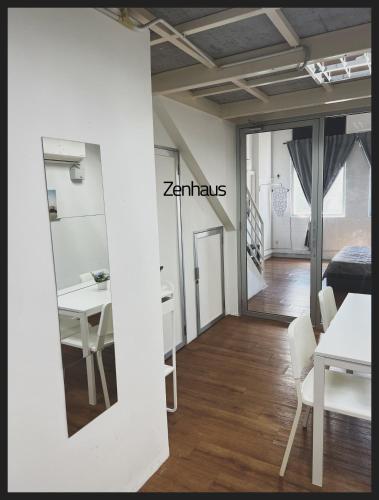 a room with a table and chairs and a mirror at THE CEO LOFT by Zenhaus in Bayan Lepas