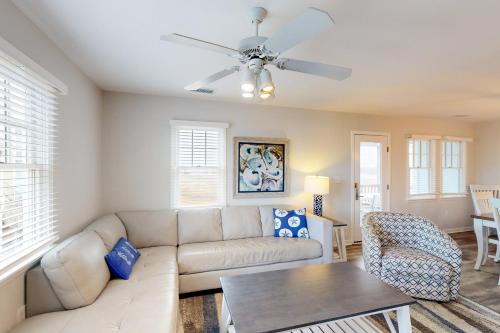 a living room with a couch and a ceiling fan at Spot at the Cape in Buxton
