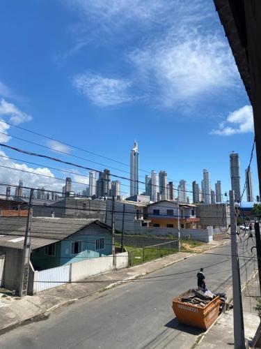 a man in a boat on a street with a factory at Casa a 1 km andando até a praia, barra sul de Balneário Camboriú in Balneário Camboriú