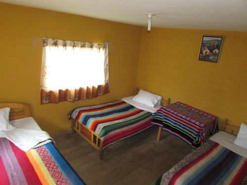 Krevet ili kreveti u jedinici u objektu Titicaca Chaska Wasi Amantani