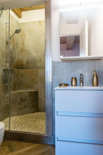 a bathroom with a shower with a sink and a toilet at Le camere di Olivia in Ravenna