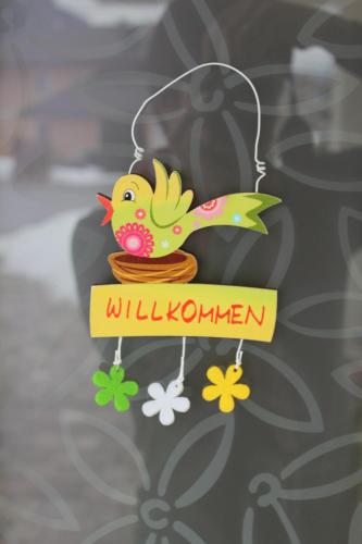 a wooden bird ornament with a sign that reads willushima at Haus Fankhauser in Dorfgastein