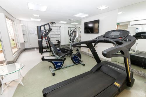 a gym with two exercise bikes and a treadmill at Royal Golden Hotel - Savassi in Belo Horizonte