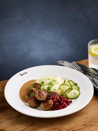 a plate of food with meatballs and vegetables on a table at Rasta Arboga in Arboga