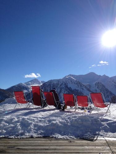 a group of chairs sitting in the snow at Casa Bamby in Cogolo