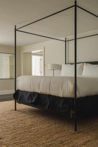 a bedroom with a large bed with a black canopy at Bourbon Orleans Hotel in New Orleans