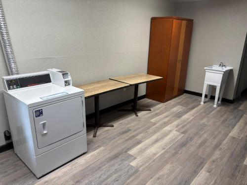 an empty room with a desk and a machine at HomeTowne Studios by Red Roof Hagerstown - Williamsport, MD in Williamsport