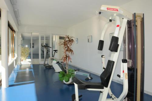 a gym with cardio equipment in a room at Ferienwohnung D24 in Orselina