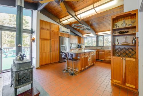 a large kitchen with wooden cabinets and a stove at Trail Access On-Site Gorgeous MCM Deck House! in Dover