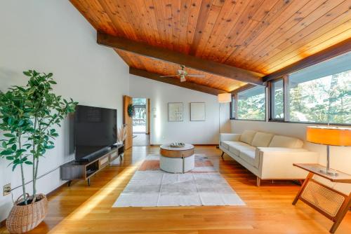 a living room with a couch and a tv at Trail Access On-Site Gorgeous MCM Deck House! in Dover