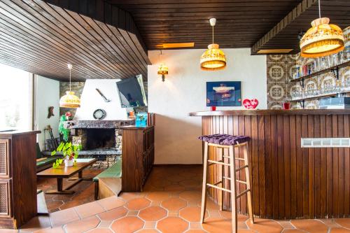 a bar in a restaurant with a bar stool at Ferienwohnung D28 in Orselina