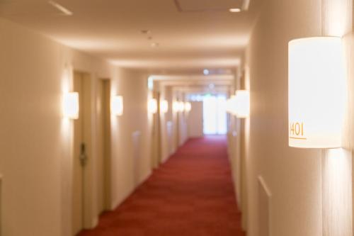 a hallway of a hotel with lights on the walls at Nishitetsu Hotel Croom Hakata in Fukuoka