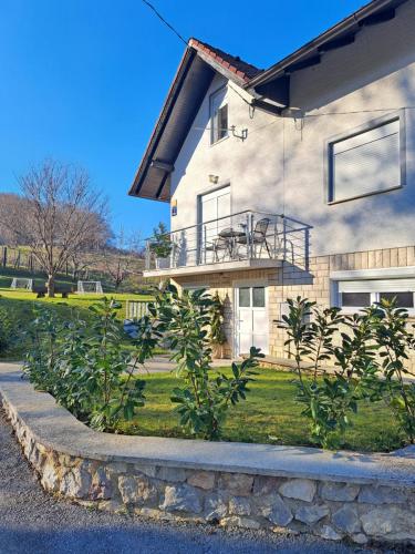 a house with a balcony on the side of it at Casa Zen in Ivanec