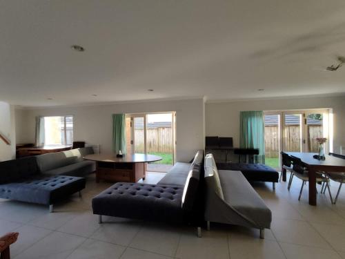 a large living room with couches and a table at 5 Bedroom sweet House 82A Richardson Road in Auckland