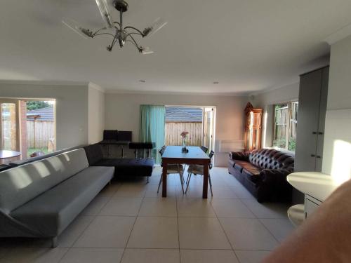 a living room with a couch and a table at 5 Bedroom sweet House 82A Richardson Road in Auckland