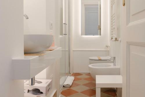 a white bathroom with a sink and a toilet at Antica Dimora sul Mare - Luxury Central Apartments - Molfetta in Molfetta