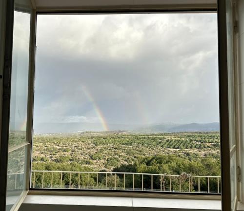 a view of a rainbow from a window at Neve ziv in Neve Ziv
