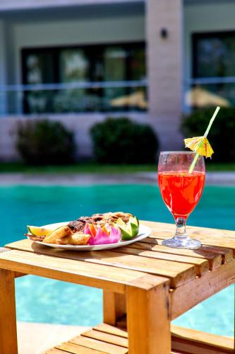 a plate of food and a drink on a table at Diani Beachfront Villa Amani at Diani in Ukunda