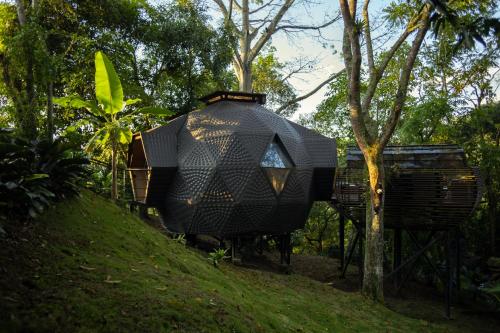 a black house sitting on top of a hill at GreenOriental Resort in La Vega