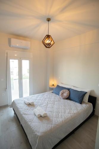 a bedroom with a large bed with towels on it at Ierapetra flats in Ierapetra