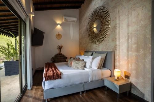 a bedroom with a bed and a mirror on the wall at GreenOriental Resort in La Vega