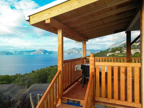 a wooden deck with a view of the water at BlueSea Faralya-Sardalya Full Deniz Manzaralı in Kızılcakaya