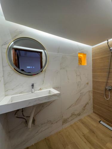 a bathroom with a sink and a mirror at Appartement Dar LALA 1 in Fez