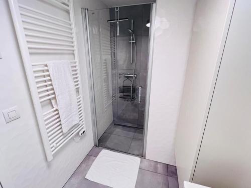 a walk in shower in a white bathroom at Lovely 1 bedroom apartment w balcony&parking-BON10 in Luxembourg