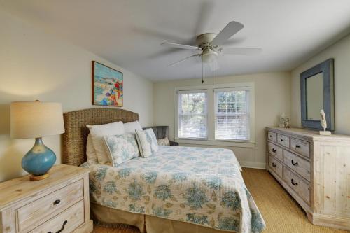 a bedroom with a bed and a ceiling fan at Tipsy Turtle - 1227 Beachview Drive in East End